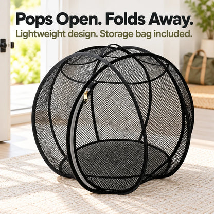 Expanded black mesh enclosure in a clean doorway setting illustrating portable use.